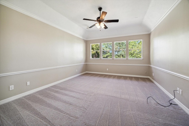 carpeted empty room with crown molding, vaulted ceiling, and ceiling fan