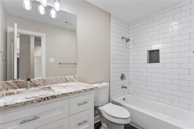 full bathroom featuring vanity, toilet, and tiled shower / bath