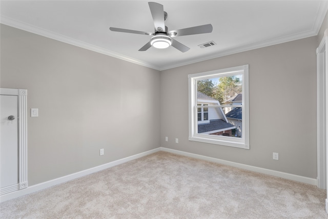 spare room with light carpet, ceiling fan, and ornamental molding