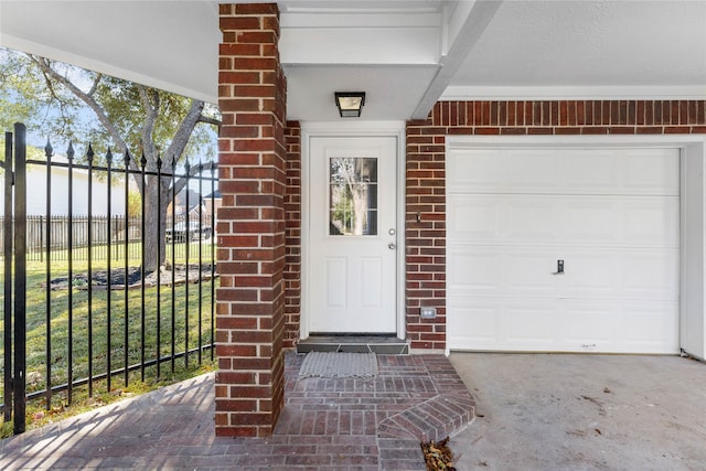 doorway to property with a garage