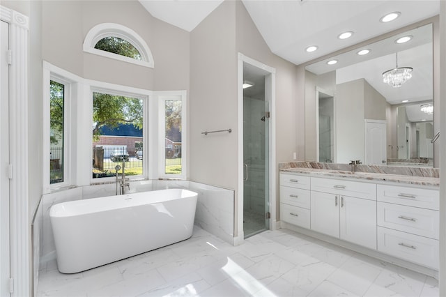 bathroom featuring plus walk in shower, vanity, a chandelier, and high vaulted ceiling