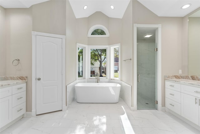 bathroom with high vaulted ceiling, vanity, and plus walk in shower