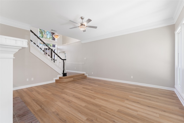 unfurnished living room featuring ceiling fan, ornamental molding, and light wood-type flooring