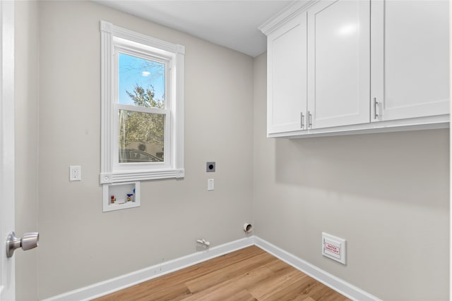 laundry area with hookup for an electric dryer, cabinets, light hardwood / wood-style flooring, and washer hookup