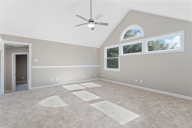 spare room with carpet, high vaulted ceiling, and ceiling fan