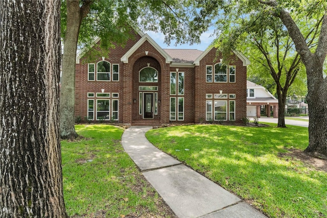 6627 Butler Oaks Ct, Spring, TX 77389 - traditional-style home featuring brick siding and a front yard