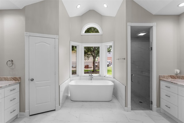 6627 Butler Oaks Ct, Spring, TX 77389 - full bathroom featuring marble look tile flooring, vanity, a shower stall, a freestanding bath, and lofted ceiling