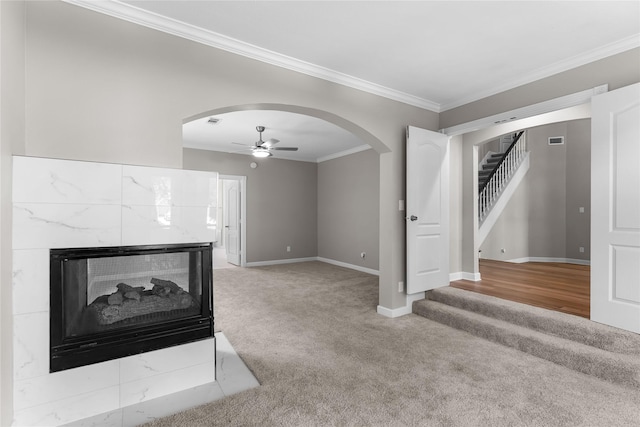 6627 Butler Oaks Ct, Spring, TX 77389 - unfurnished living room featuring light carpet, stairway, arched walkways, crown molding, and baseboards