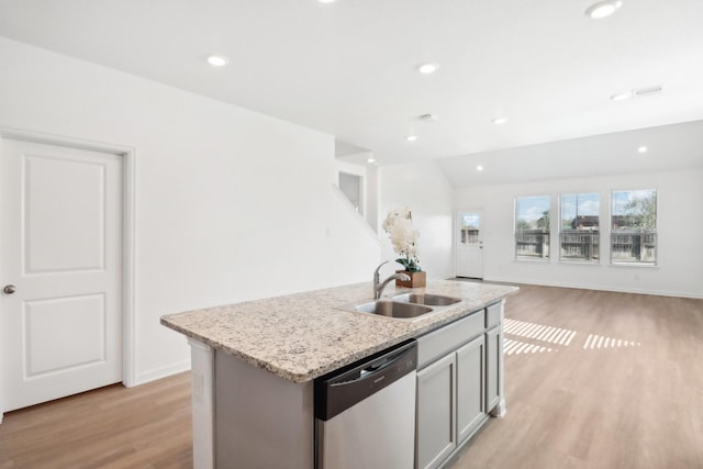 kitchen featuring gray cabinets, dishwasher, sink, a kitchen island with sink, and light hardwood / wood-style floors