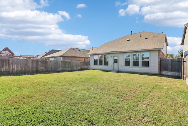 rear view of house with a lawn