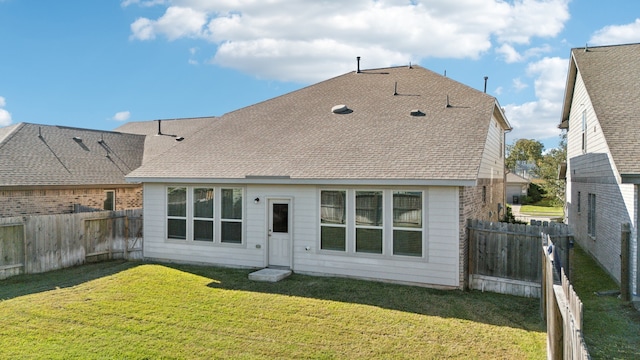 back of house featuring a yard