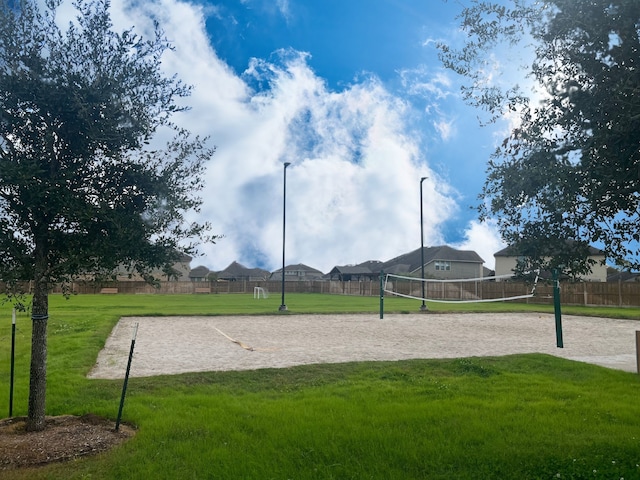 view of home's community featuring a yard and volleyball court