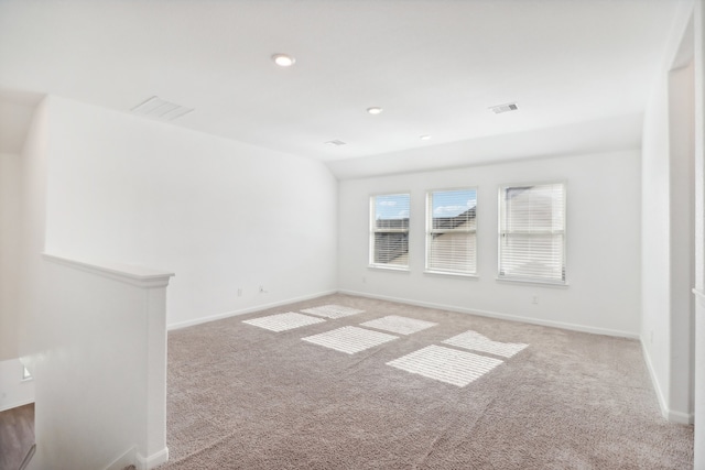 unfurnished room with lofted ceiling and carpet flooring