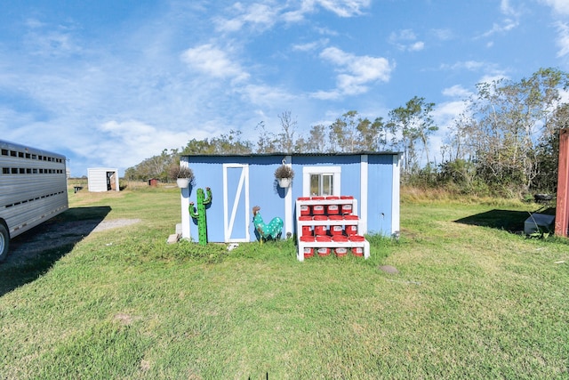 view of outbuilding featuring a yard