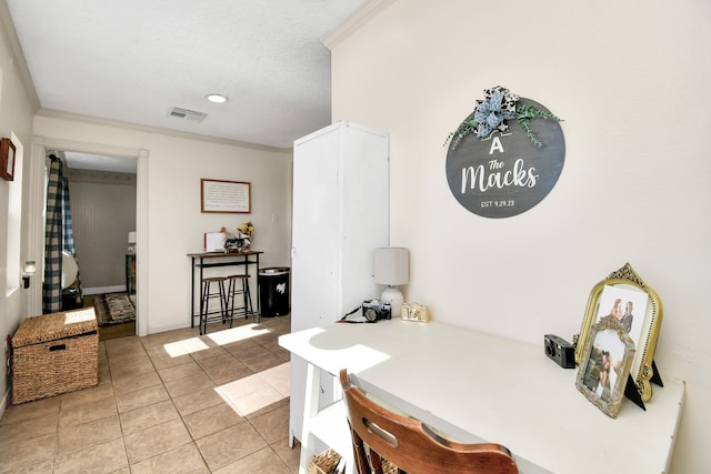 dining space with crown molding and light tile patterned floors