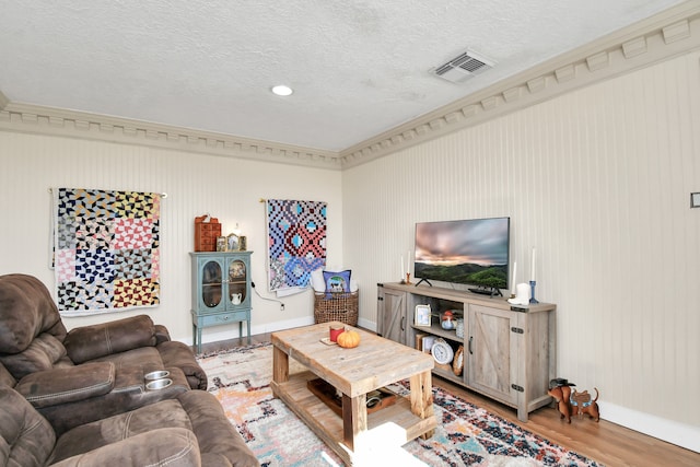 living room with a textured ceiling and light hardwood / wood-style floors