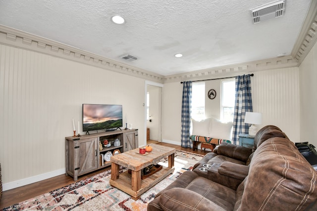 living room with wood-type flooring and a textured ceiling