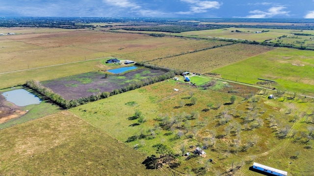 drone / aerial view featuring a rural view and a water view