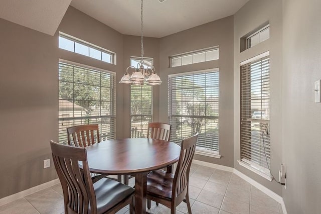 tiled dining area with a wealth of natural light and an inviting chandelier