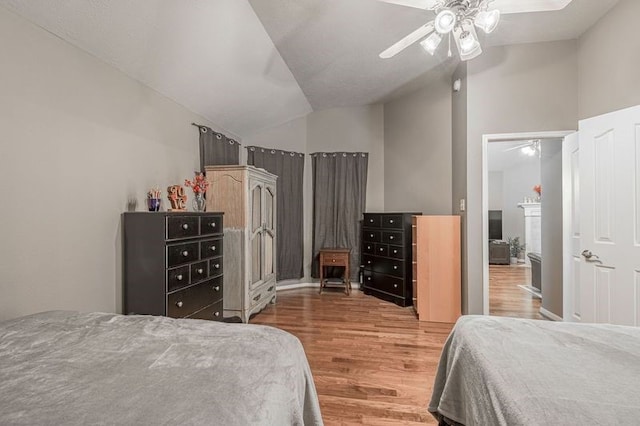 bedroom featuring hardwood / wood-style floors, ceiling fan, and vaulted ceiling