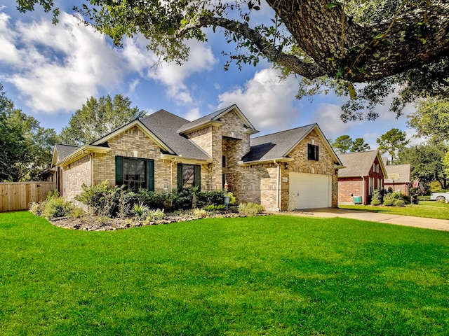 view of front of property with a front yard and a garage