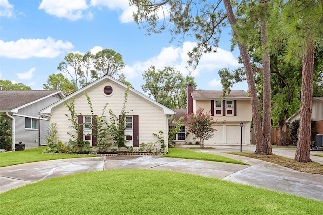 view of front facade with central AC unit, a garage, and a front lawn