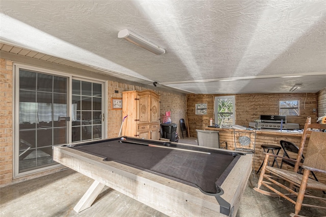 game room featuring brick wall, carpet flooring, and pool table