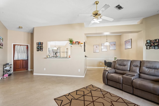 living room featuring ceiling fan with notable chandelier