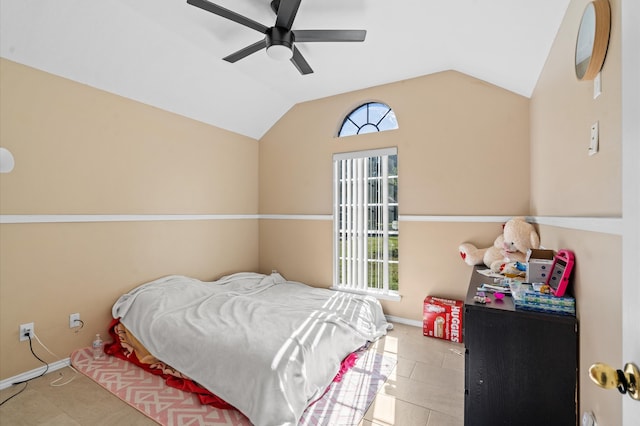 bedroom featuring ceiling fan, lofted ceiling, light tile patterned floors, and multiple windows