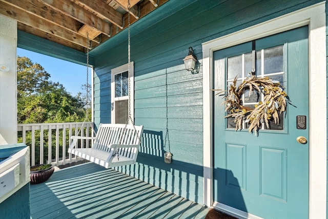 doorway to property featuring covered porch