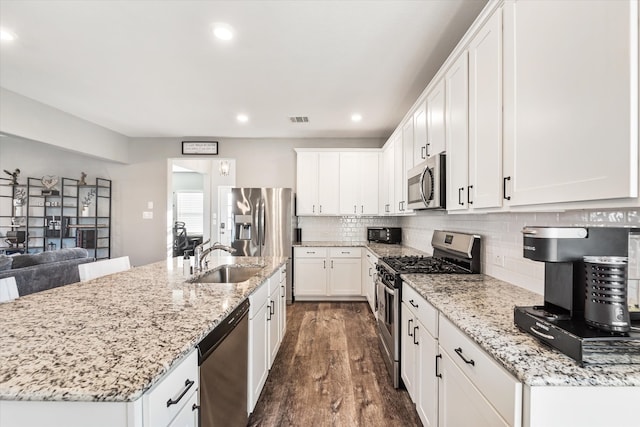 kitchen with white cabinets, sink, stainless steel appliances, and dark wood-type flooring