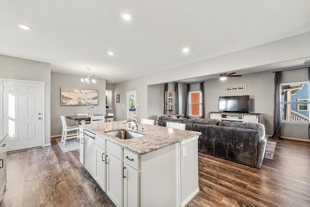 kitchen with a center island with sink, dark hardwood / wood-style floors, white cabinets, and sink