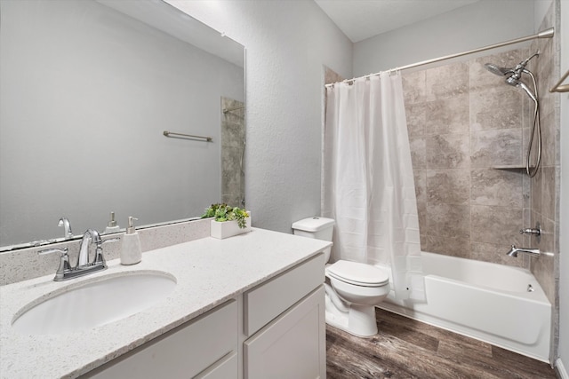 full bathroom featuring vanity, wood-type flooring, shower / bath combo, and toilet