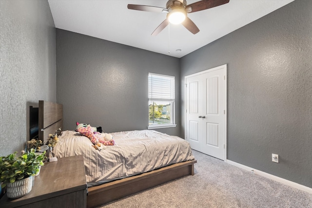 carpeted bedroom featuring ceiling fan