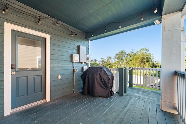 wooden deck featuring a grill