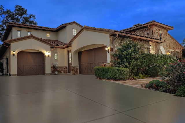 mediterranean / spanish house with a garage