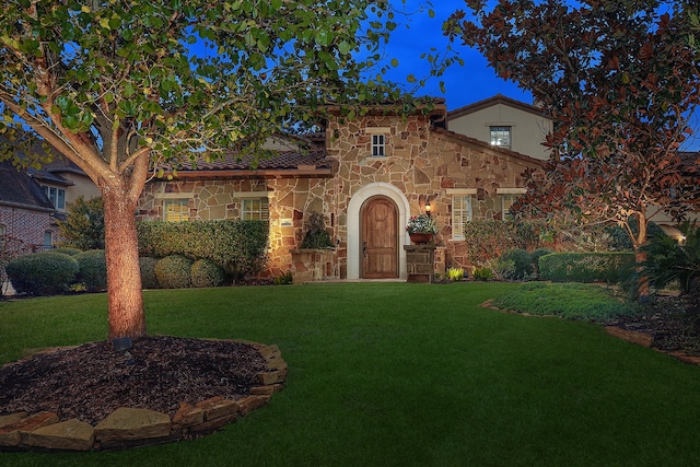 mediterranean / spanish-style house with a front lawn