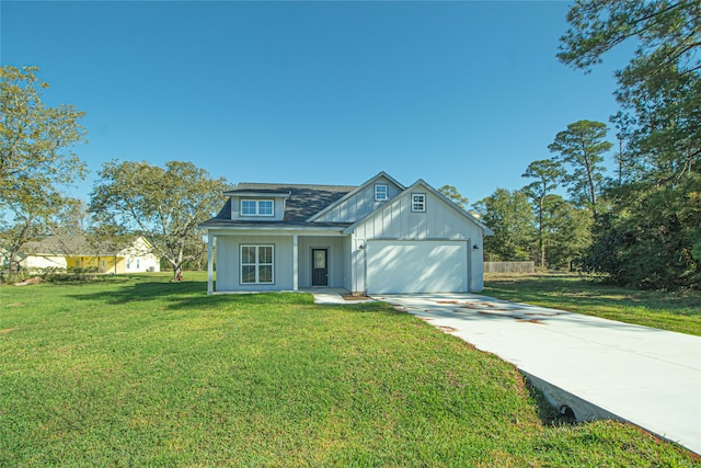 view of front of property featuring a front yard and a garage