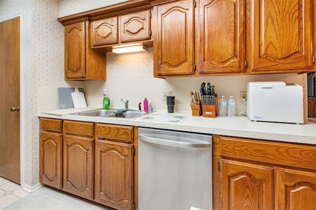 kitchen with sink, light tile patterned flooring, and stainless steel dishwasher