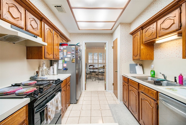 kitchen featuring sink, light tile patterned flooring, and stainless steel appliances