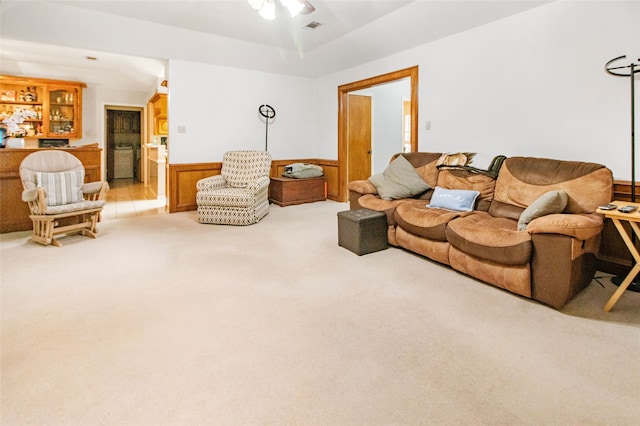 carpeted living room featuring bar, ceiling fan, and lofted ceiling