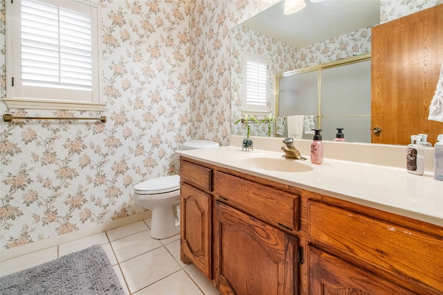 bathroom with tile patterned flooring, vanity, toilet, and walk in shower