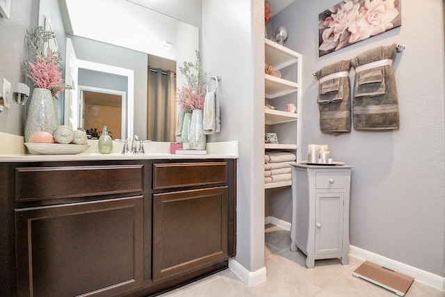 bathroom with tile patterned flooring and vanity