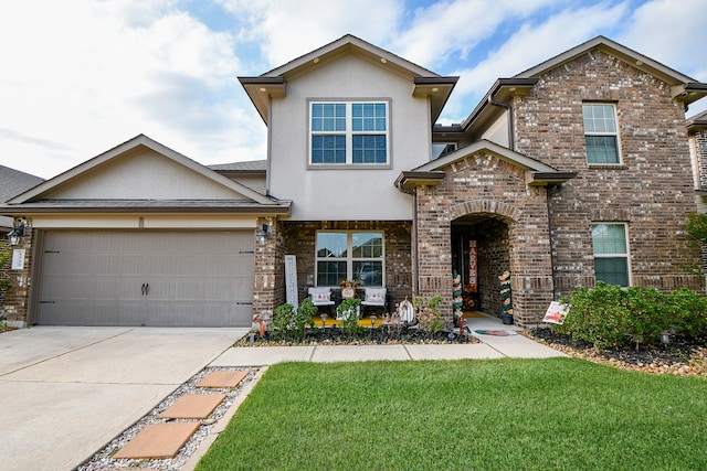 view of front of property with a garage and a front yard