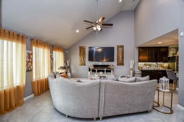 tiled living room featuring ceiling fan and high vaulted ceiling