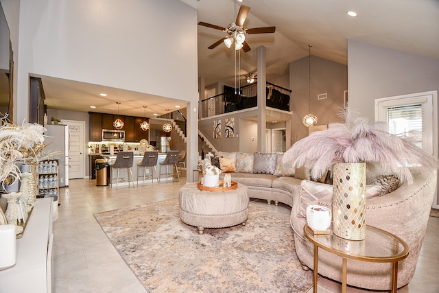 living room featuring ceiling fan, high vaulted ceiling, and light tile patterned floors