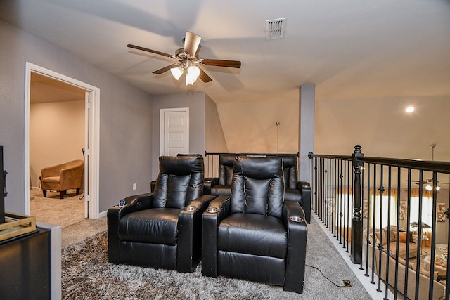 cinema room featuring ceiling fan, carpet floors, and vaulted ceiling