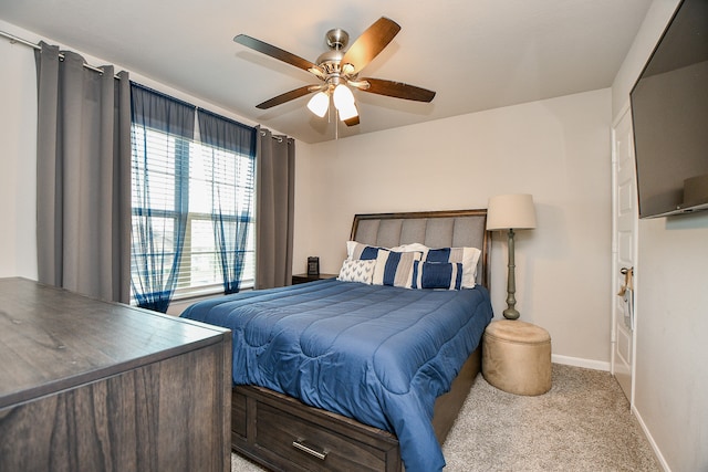 bedroom with light carpet and ceiling fan