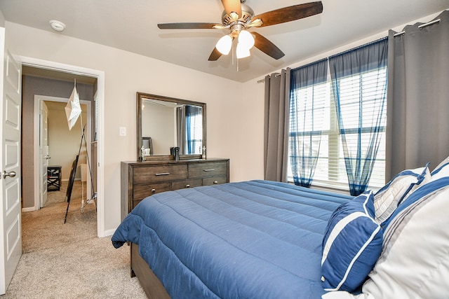 bedroom with ceiling fan and light carpet