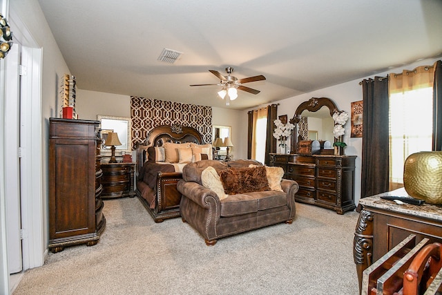 bedroom with ceiling fan and light carpet